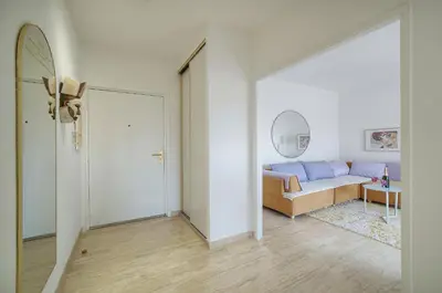 a living room with a couch and a mirror at Calme et Lumineux 2 chambres BALCON Vue MER-FORVILLE A2B262 in Cannes