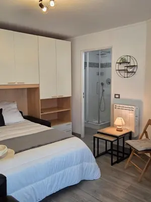 a bedroom with a bed and a table and a shower at Étoile Riviera - Studio 2P, Centre, Plages & Palais in Cannes