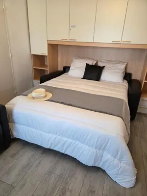 a large bed with a hat on top of it at Étoile Riviera - Studio 2P, Centre, Plages & Palais in Cannes
