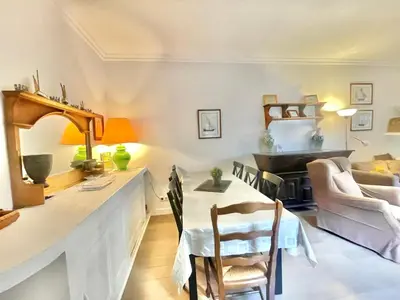 a living room with a table and chairs at La Marjolette by Welcome to Cannes in Cannes