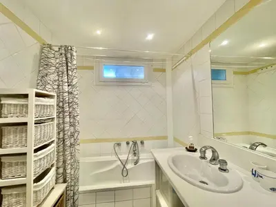 a bathroom with a sink and a tub and a mirror at La Marjolette by Welcome to Cannes in Cannes