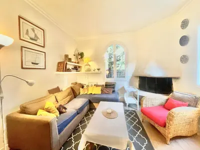 a living room with a couch and a table at La Marjolette by Welcome to Cannes in Cannes