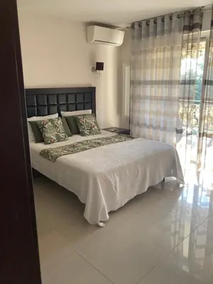 a bedroom with a large bed and a window at Superbe appartement T3 à 2km centre Cannes in Le Cannet