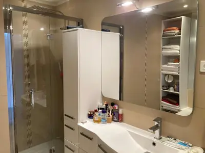 a bathroom with a shower and a sink and a mirror at Superbe appartement T3 à 2km centre Cannes in Le Cannet