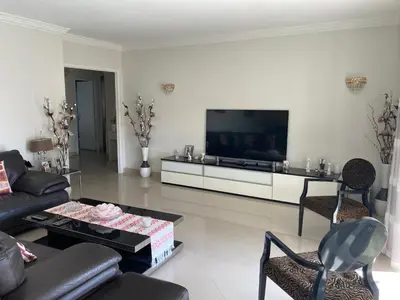 a living room with a couch and a flat screen tv at Superbe appartement T3 à 2km centre Cannes in Le Cannet