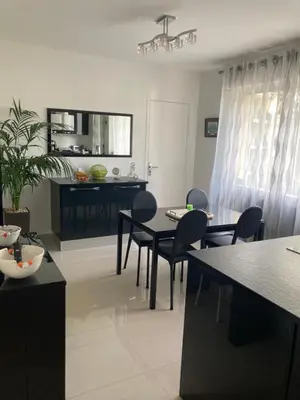 a kitchen and dining room with a table and chairs at Superbe appartement T3 à 2km centre Cannes in Le Cannet