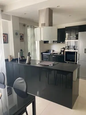 a kitchen with a large island in the middle at Superbe appartement T3 à 2km centre Cannes in Le Cannet