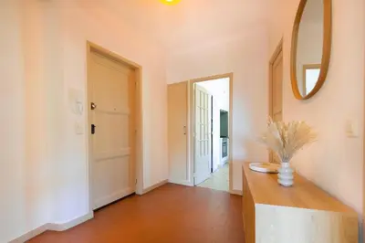 a hallway with a table and a mirror at Apartment near Croisette and Cannes festival in Le Cannet
