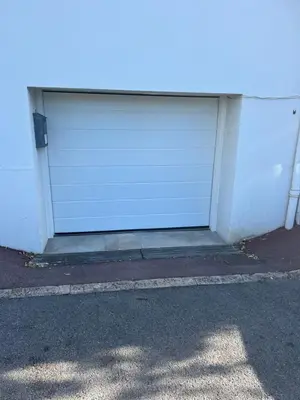 a white garage door on the side of a building at Apartment near Croisette and Cannes festival in Le Cannet