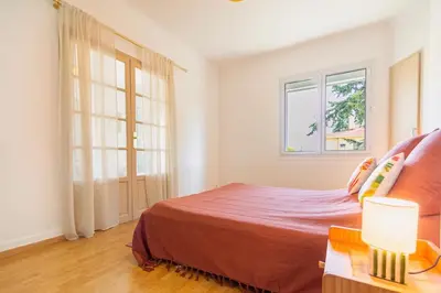 a bedroom with a bed and two windows at Apartment near Croisette and Cannes festival in Le Cannet