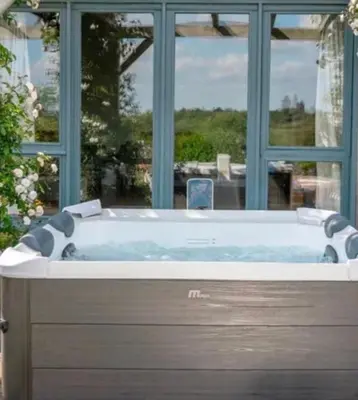 a bath tub in front of a window at Eryvazur in Vallauris