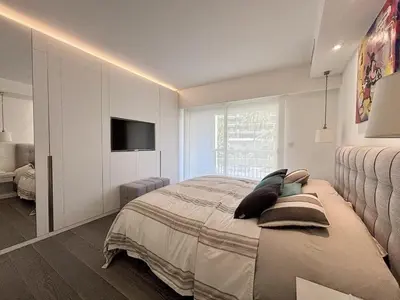 a bedroom with a bed and a television in it at Superbe 2 pièces - Première ligne Croisette in Cannes