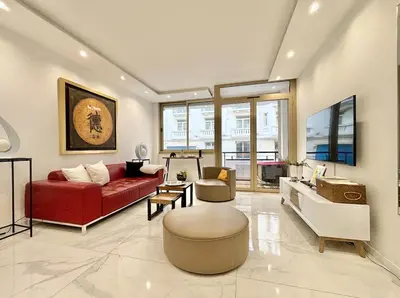 a living room with a red couch and a table at Cannes one bedroom apartment - 20LM1 in Cannes