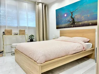 a bedroom with a bed and a painting on the wall at Cannes one bedroom apartment - 20LM1 in Cannes