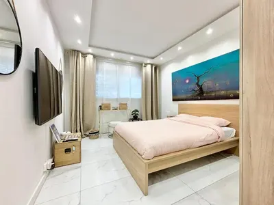 a bedroom with a bed and a painting on the wall at Cannes one bedroom apartment - 20LM1 in Cannes