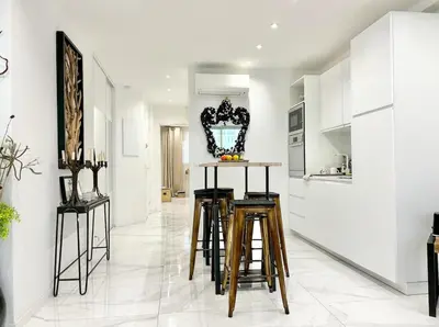 a kitchen with white walls and stools in a room at Cannes one bedroom apartment - 20LM1 in Cannes