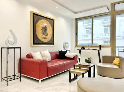 a living room with a red couch and a chair at Cannes one bedroom apartment - 20LM1 in Cannes
