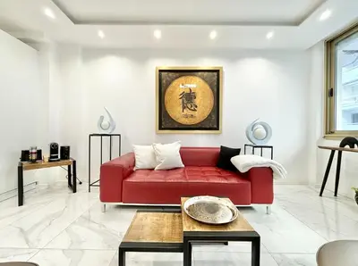 a red couch in a living room with a table at Cannes one bedroom apartment - 20LM1 in Cannes