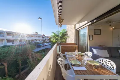 a table and chairs on a balcony with a view at 1-Br Apartment Near the Beach and the Croisette Palm Beach in Cannes