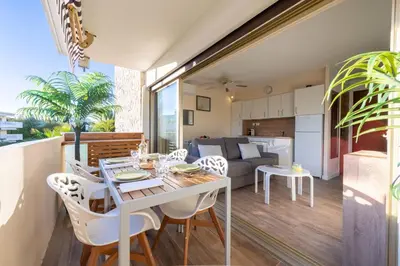 a kitchen and living room with a table and chairs at 1-Br Apartment Near the Beach and the Croisette Palm Beach in Cannes
