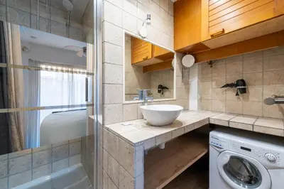 a bathroom with a sink and a washing machine at 1-Br Apartment Near the Beach and the Croisette Palm Beach in Cannes