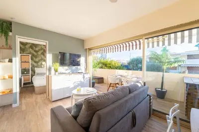 a living room with a couch and a large window at 1-Br Apartment Near the Beach and the Croisette Palm Beach in Cannes