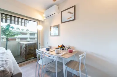 a small dining room with a table and chairs at 1-Br Apartment Near the Beach and the Croisette Palm Beach in Cannes