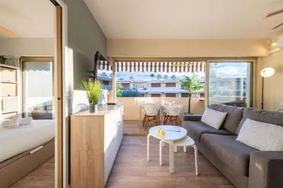 a living room with a couch and a table at 1-Br Apartment Near the Beach and the Croisette Palm Beach in Cannes