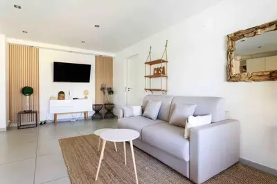 a living room with a couch and a table at Cannes 2 bedrooms apartment & 2 bathrooms - 160A in Cannes
