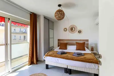 a bedroom with a bed and a large window at Cannes 2 bedrooms apartment & 2 bathrooms - 160A in Cannes