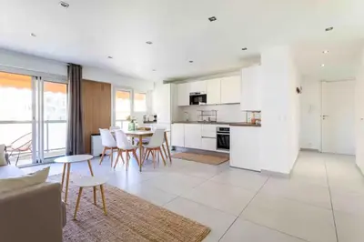a kitchen and living room with a table and chairs at Cannes 2 bedrooms apartment & 2 bathrooms - 160A in Cannes