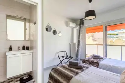 a bedroom with a bed and a sink and a window at Cannes 2 bedrooms apartment & 2 bathrooms - 160A in Cannes