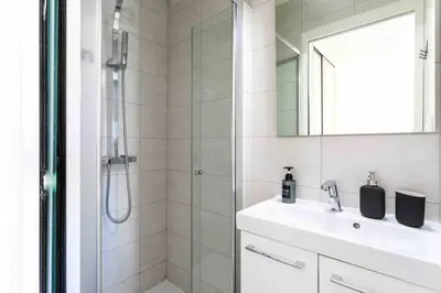 a bathroom with a shower and a sink and a mirror at Cannes 2 bedrooms apartment & 2 bathrooms - 160A in Cannes