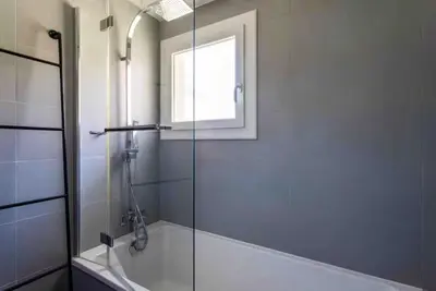 a bathroom with a shower and a bath tub with a window at Cannes 2 bedrooms apartment & 2 bathrooms - 160A in Cannes