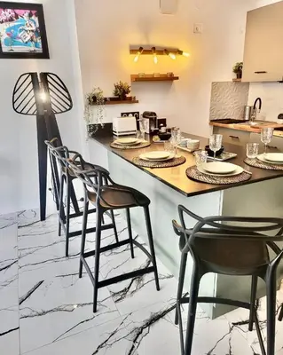 a kitchen with a counter with chairs and a table at Cannes 1 bedroom apartment - 20LM3 in Cannes