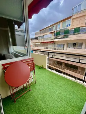 a red chair sitting on the balcony of a building at Cannes 1 bedroom apartment - 20LM3 in Cannes