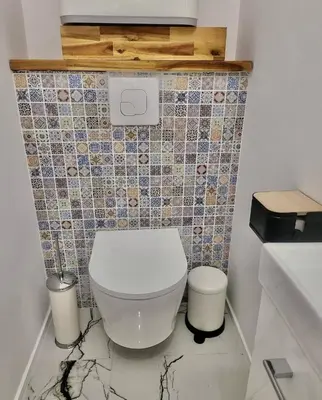a bathroom with a toilet and a tiled wall at Cannes 1 bedroom apartment - 20LM3 in Cannes