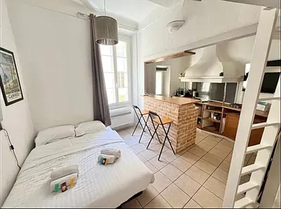 a bedroom with a bunk bed and a kitchen at Cannes 1 bedroom apartment - 12RP1 in Cannes