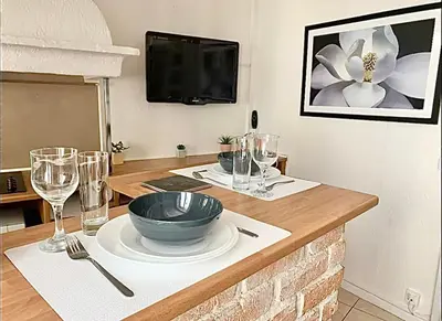 a table with a bowl and wine glasses on it at Cannes 1 bedroom apartment - 12RP1 in Cannes