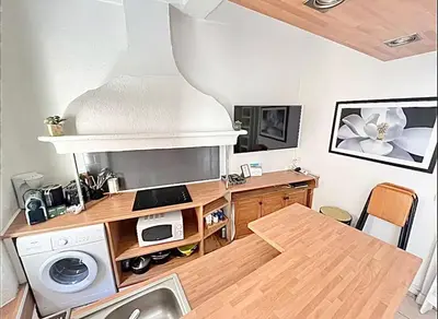 a kitchen with a table and a stove and a microwave at Cannes 1 bedroom apartment - 12RP1 in Cannes