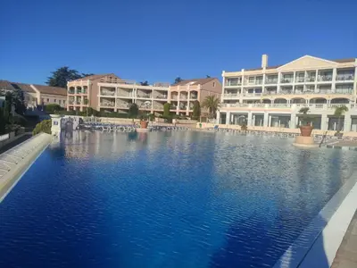 a large swimming pool in front of a building at Studio cabine Cannes - Vue mer - Piscine - Parking in Cannes