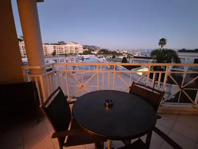 a table and chairs on a balcony with a view at Studio cabine Cannes - Vue mer - Piscine - Parking in Cannes