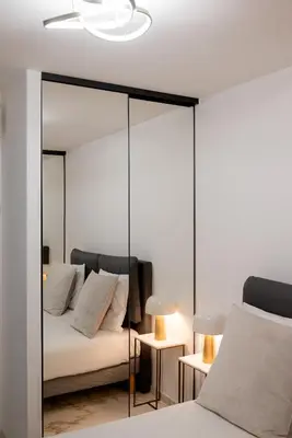 a bedroom with a mirror and a bed at Rez-de-Jardin à Cannes Centre - Luxe & Design in Cannes