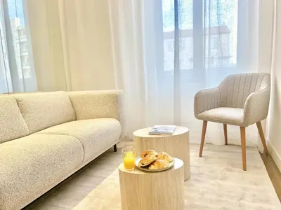a living room with a couch and a chair at The Cosy Clémenceau in Cannes