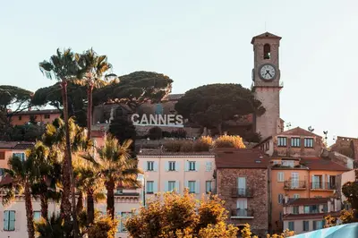 a building with a clock tower on top of a city at Atelier Meynadier in Cannes