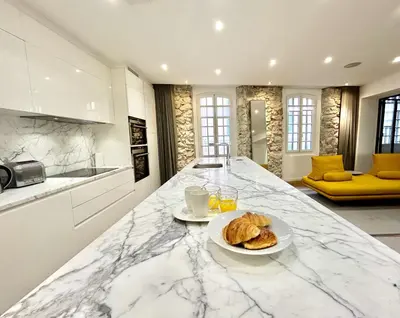 a kitchen with a counter with a plate of food on it at Atelier Meynadier in Cannes