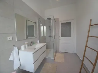a white bathroom with a sink and a shower at Lecerf in Cannes