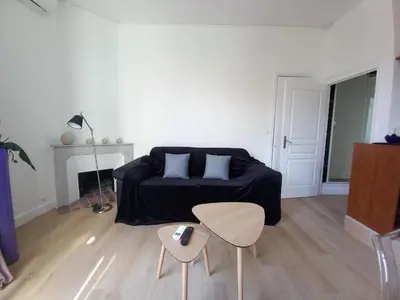a living room with a couch and a table at Lecerf in Cannes