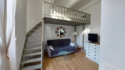 a living room with a couch and a loft bed at Studio élégant pour 4 personnes, à quelques pas de la Croisette in Cannes