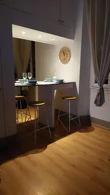 a kitchen with a table and stools in a room at Studio élégant pour 4 personnes, à quelques pas de la Croisette in Cannes